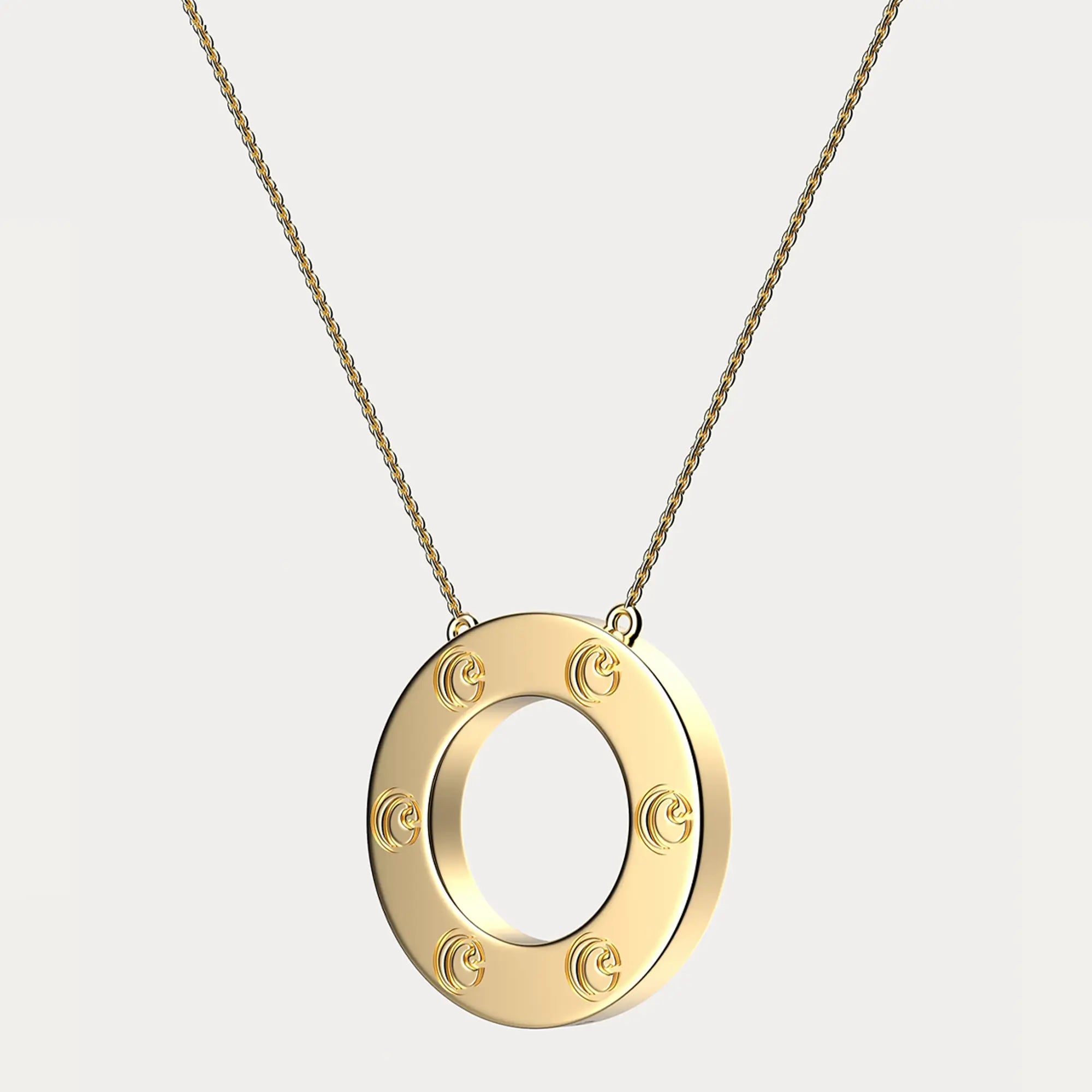 Gold pendant necklace with circular design and decorative elements.
