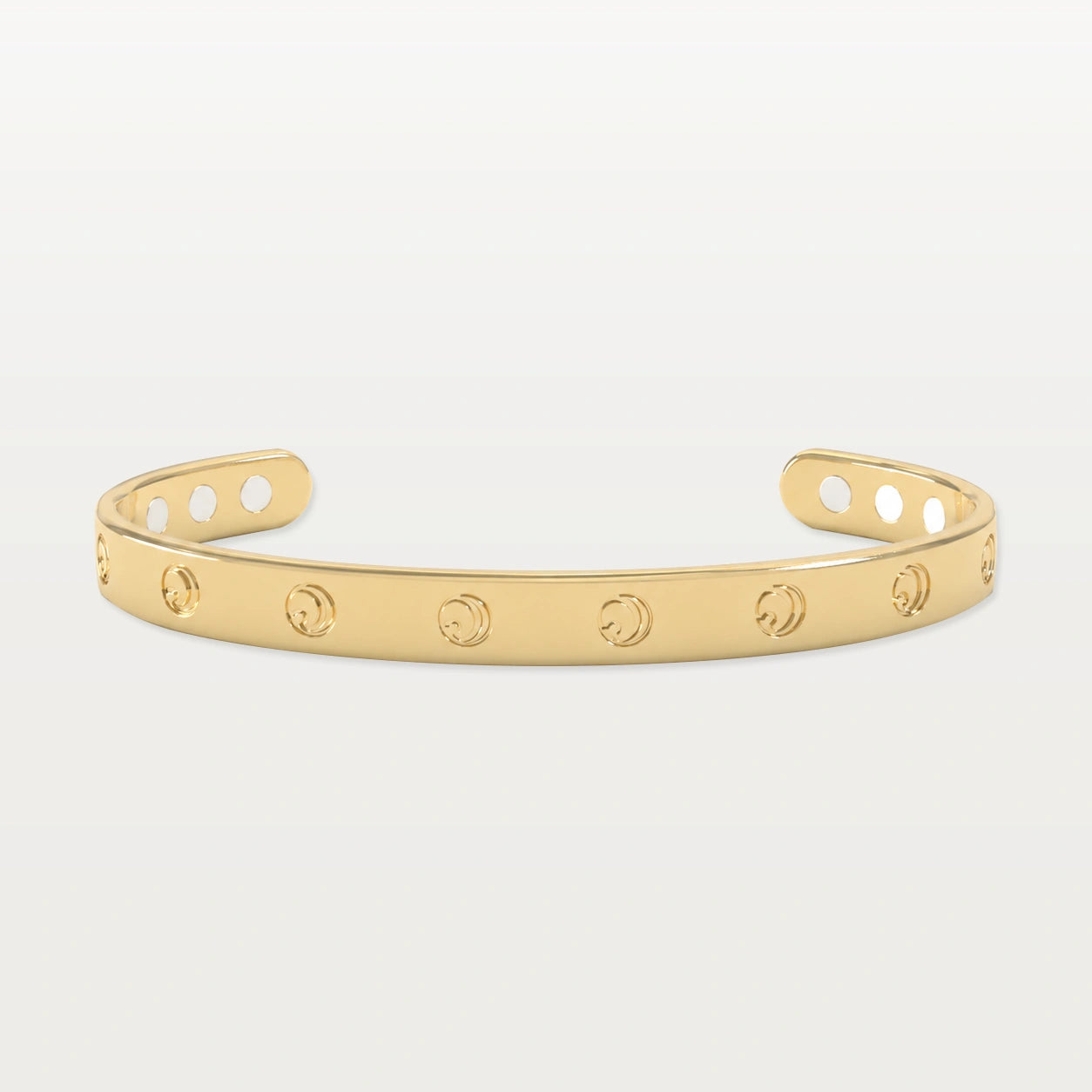 Gold bracelet with circular engravings, open design on a white background.