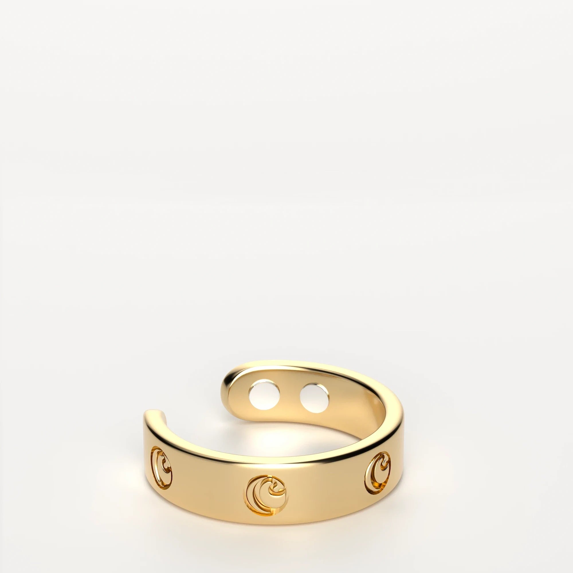 Gold open band ring with circular cutout design on white background.